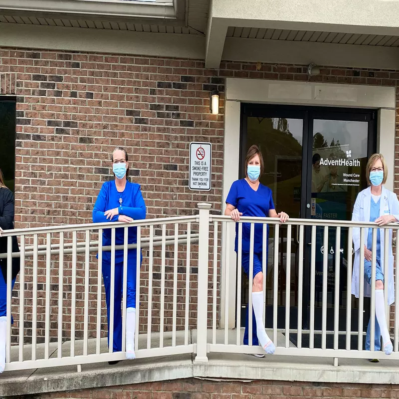 Four AdventhHealth women standing in front of their workplace