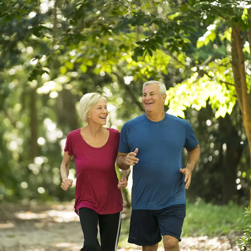 Older couple Jogging through the woods