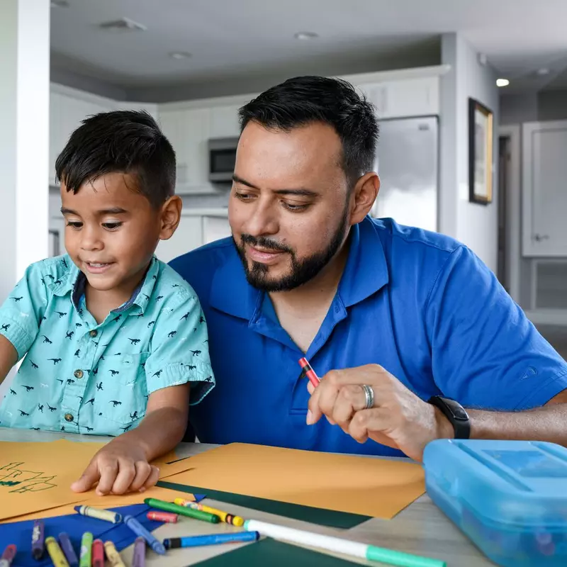 Man coloring with his son