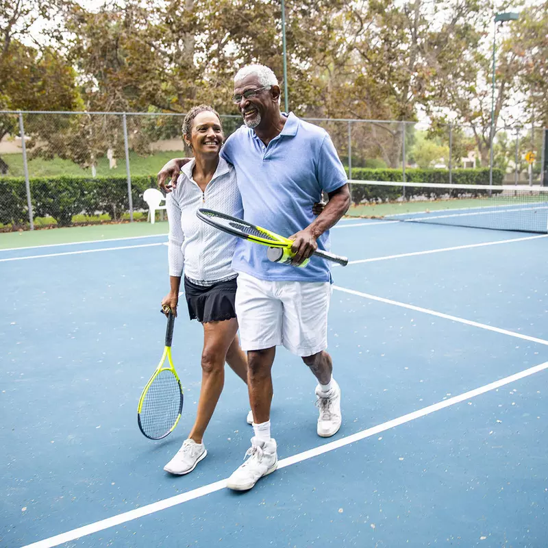 couple walks away from tennis court feeling great