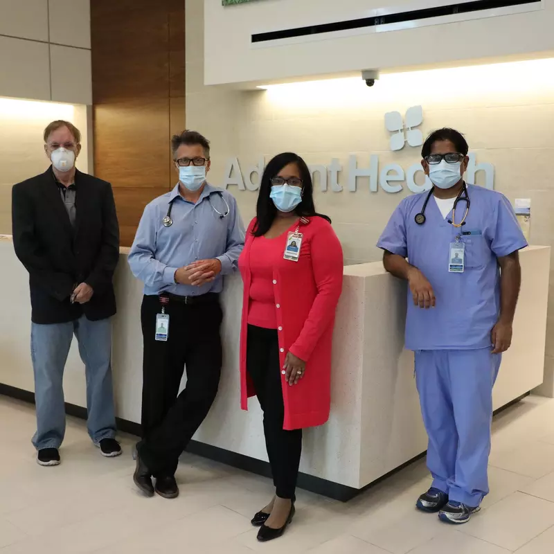 Clinicians posed in front of front desk