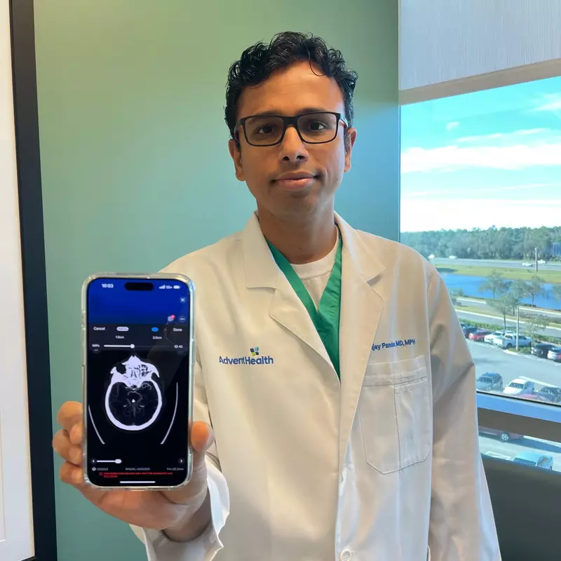 Dr. Pandav holding phone using AI technology.