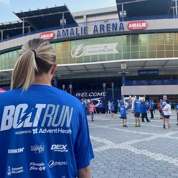 Bolt Run runner stands in front of Amalie Arena 