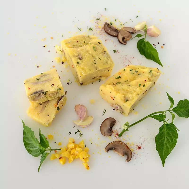 sliced squares of polenta with mushrooms and herbs