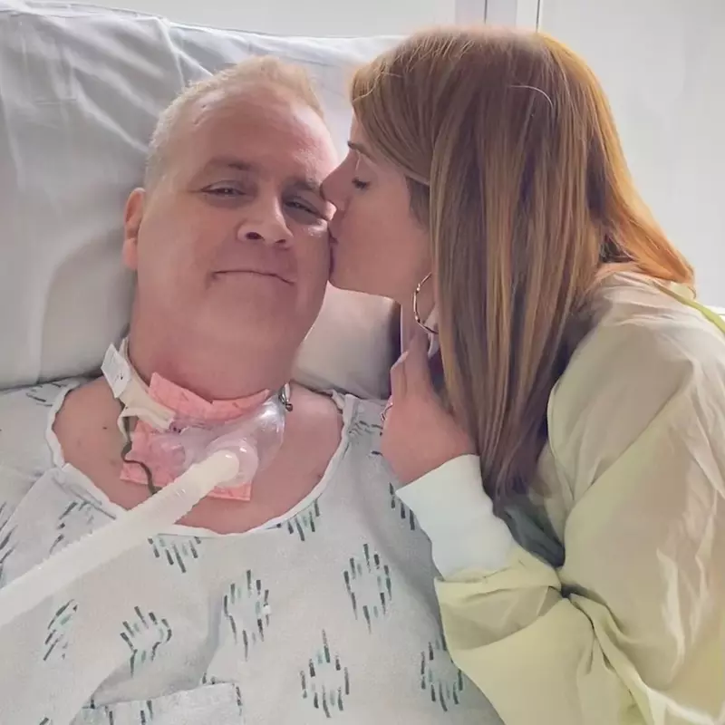 Karen Wilkinson gives her husband David a kiss on the cheek while he's in the hospital.