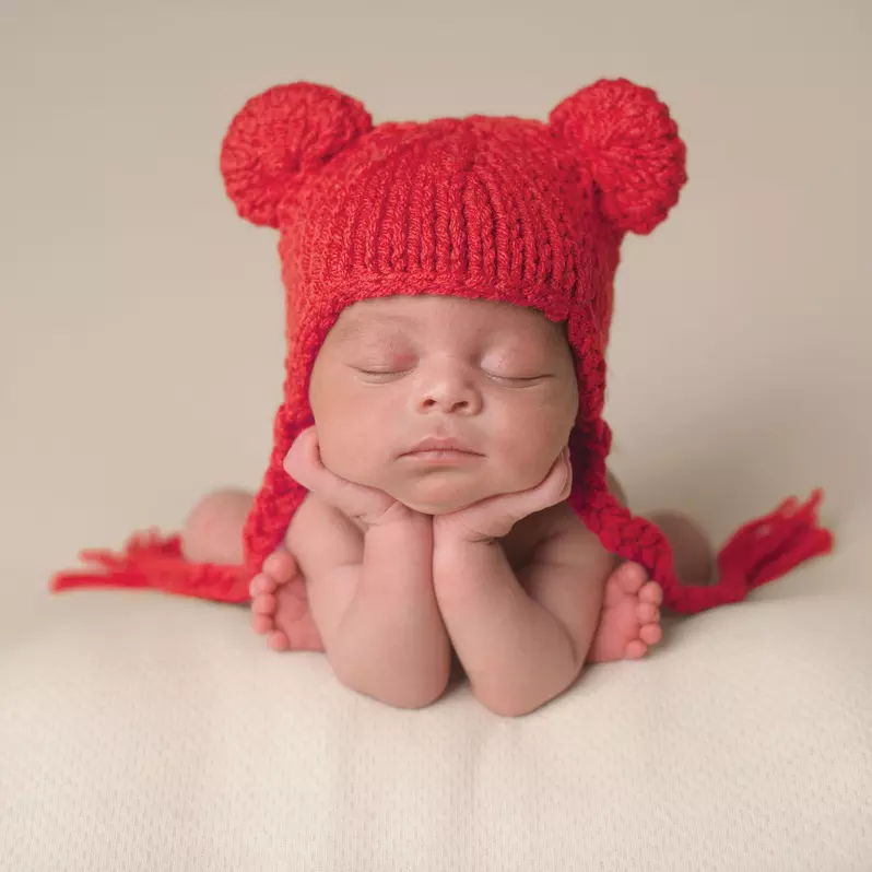 Baby wearing red heart hat