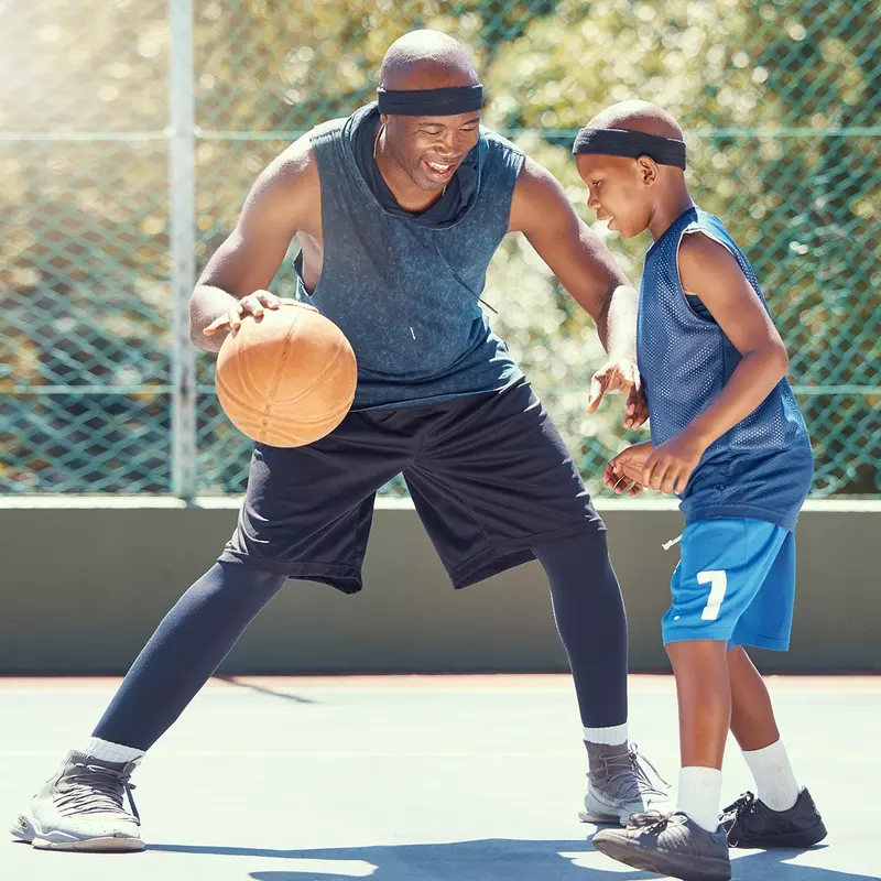 A Father and Son Play Basketball on a outdoor court