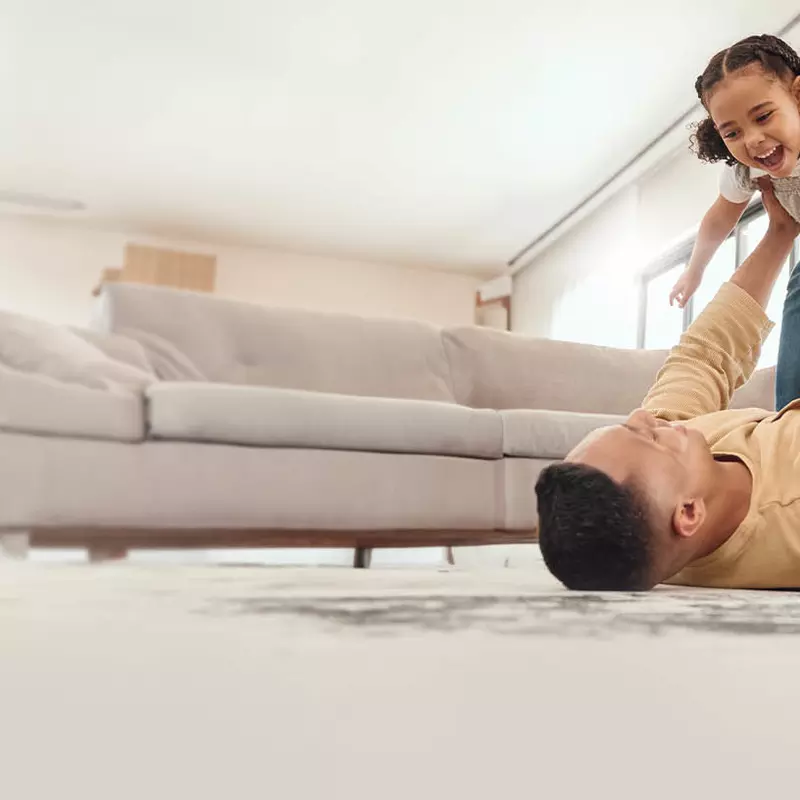 Family at home playing in living room