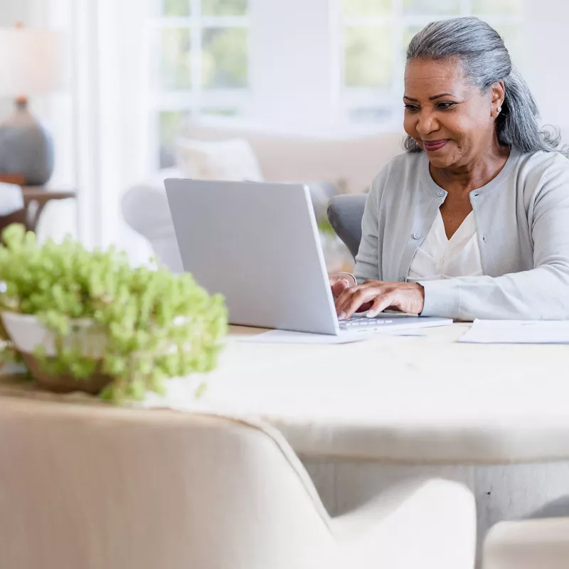 A woman using her computer at home