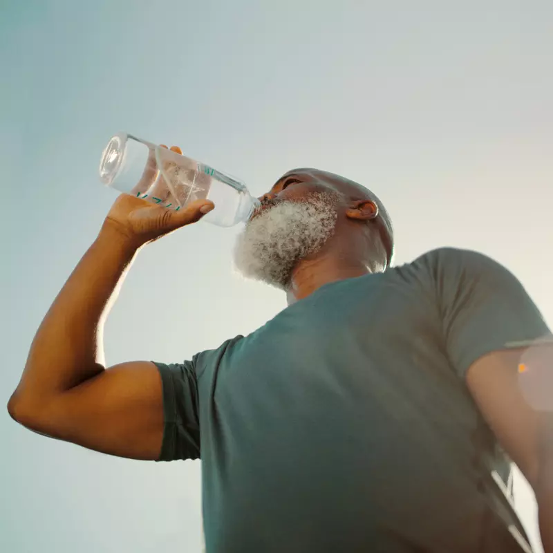 Man drinking water from a bottle.