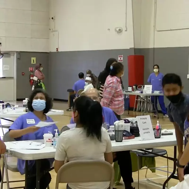 Physicians and Patients Gather for a Health Event in a School Gymnasium