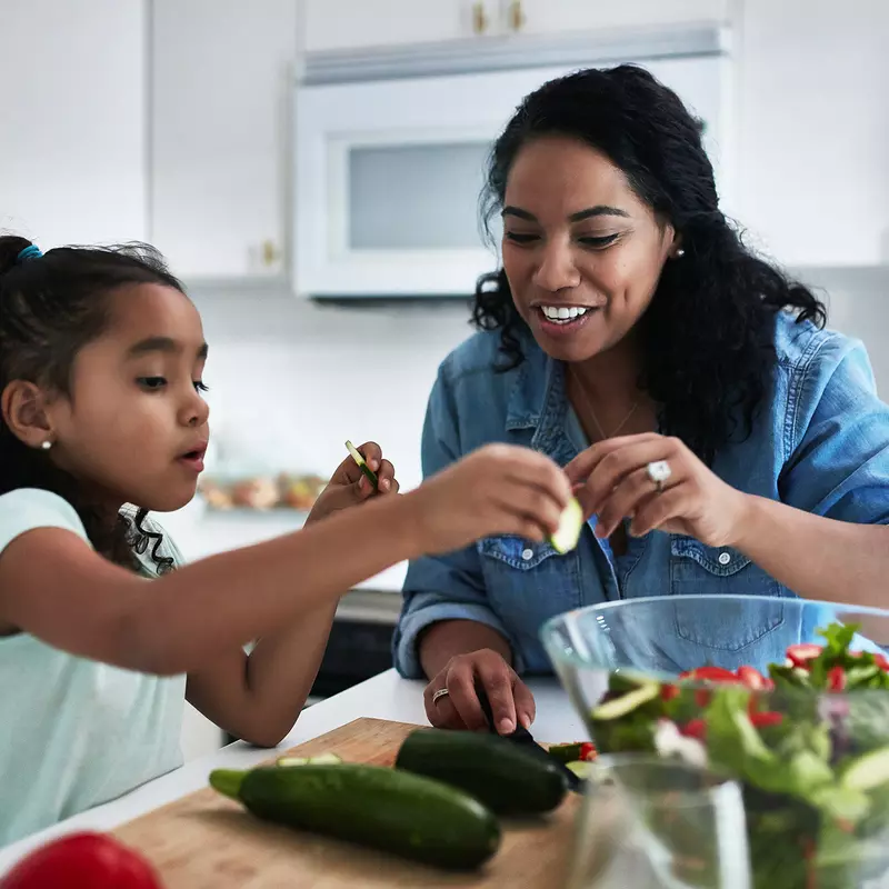 A Mother and Her Daughter Make a Healthy Salad In the Kitchen