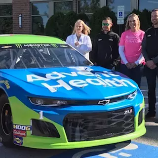 Kurt Busch and Kyle Larson visited cancer patients and  unveiled the No. 1 car accented in pink for breast cancer awareness 