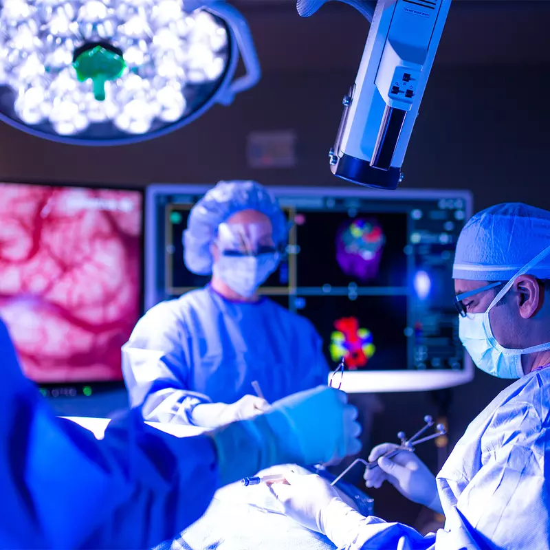 Neurosurgeon team in an operating room performing a surgery.