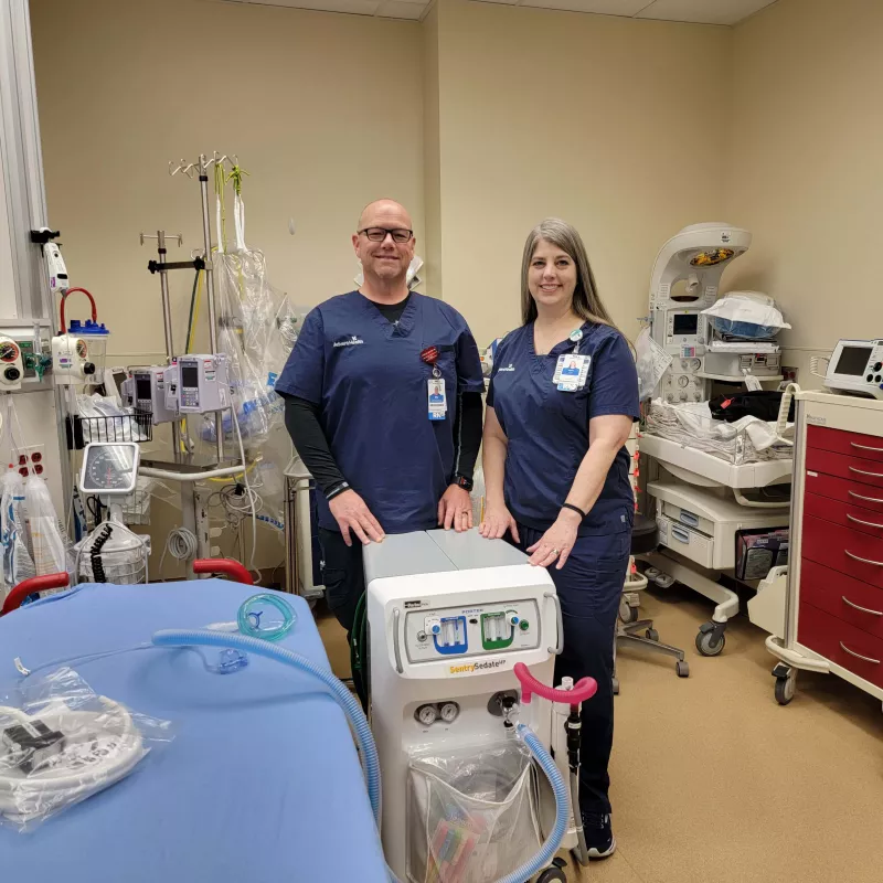 Billy Nolan, RN and Janet Caldwell, RN stand in front of nitrous oxide machine