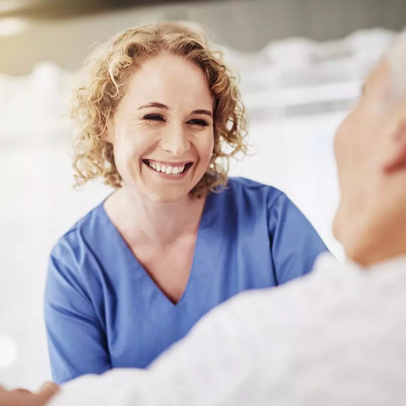 Nurse smiling at an elderly patient
