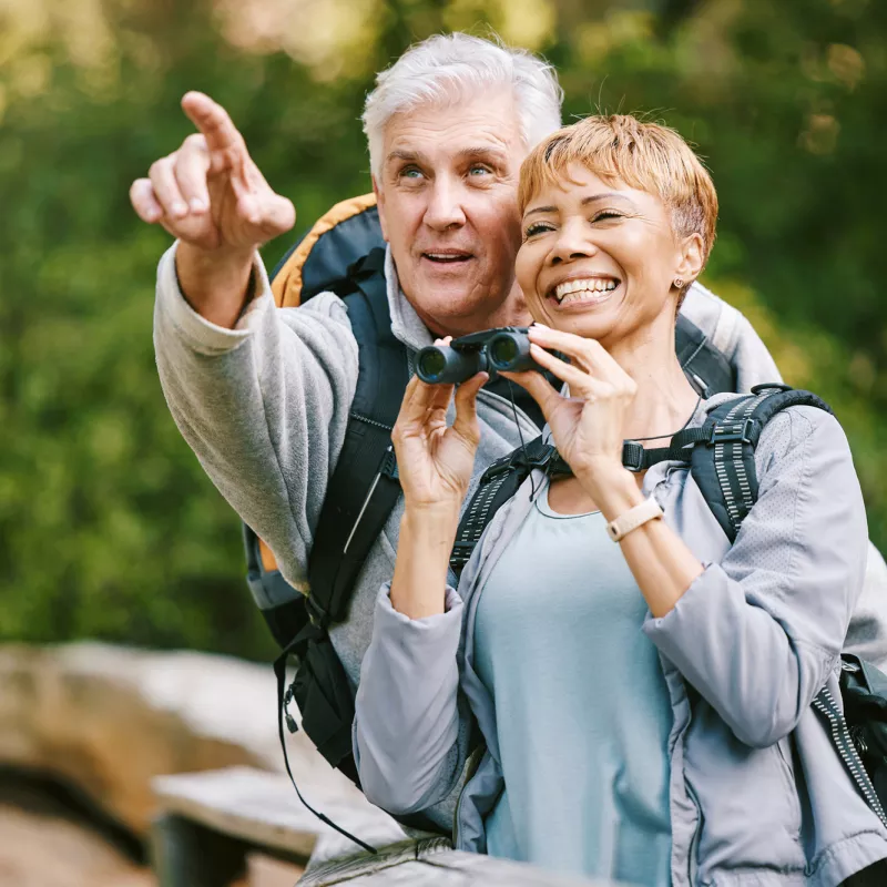 Older couple bird watching together.