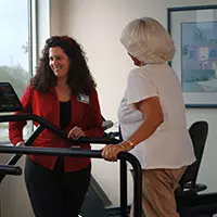 a woman on a treadmill in a doctors office