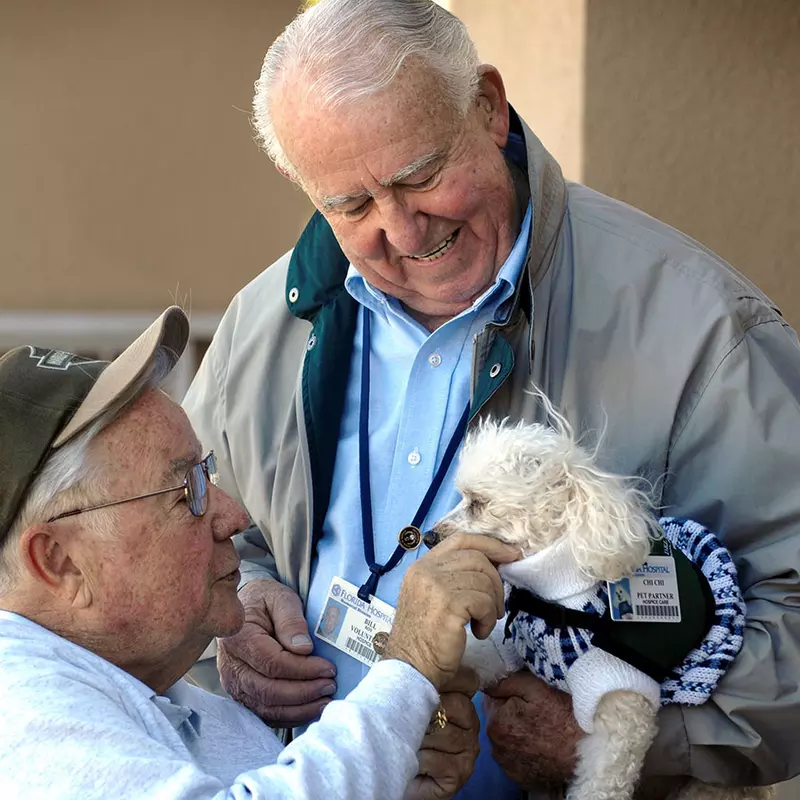 a senior visiting a dog