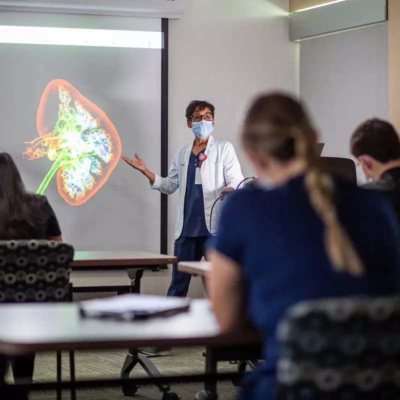 An AdventHealth physician conducting a lecture to her colleagues.