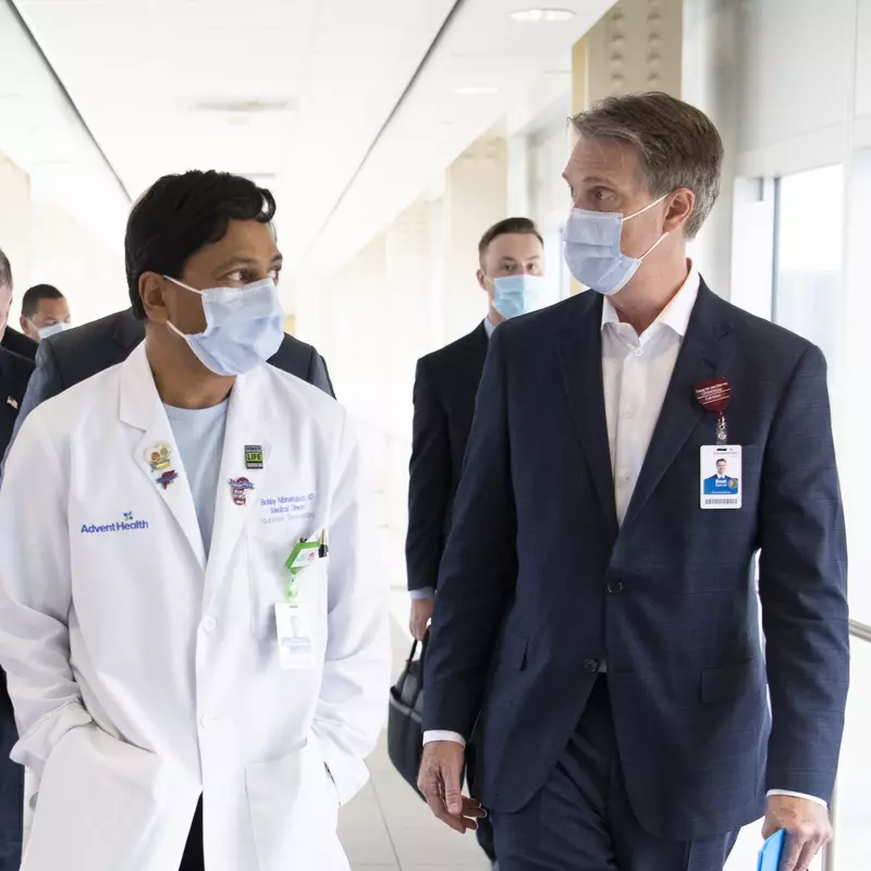 Two physicians walking in a hallway