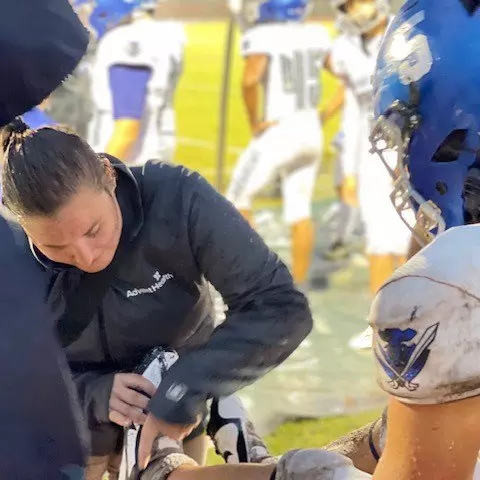 AdventHealth athletic trainer providing care during Matanzas High School’s football game 