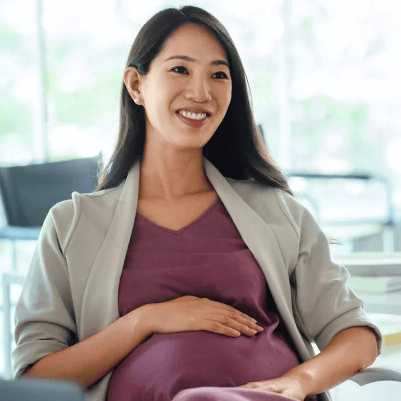 Pregnant woman smiling while at an appointment.