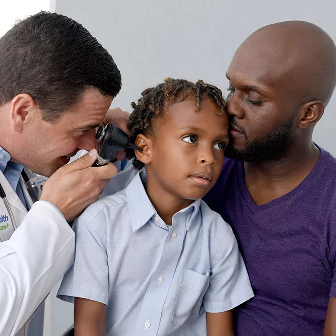 Provider checking child's ear