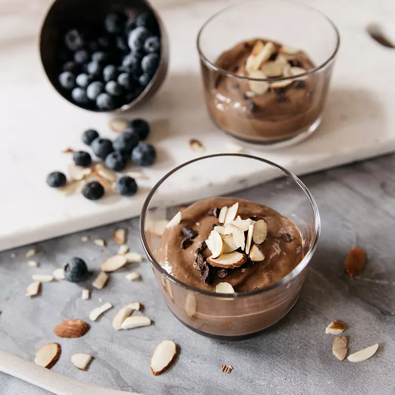 A chocolate mouse with almonds and blueberries.