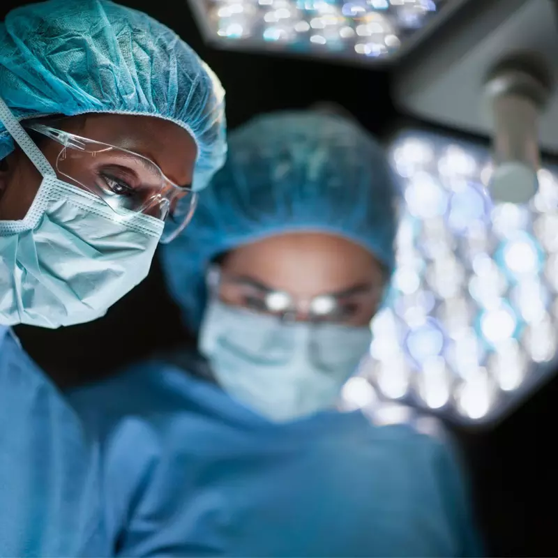 Two surgeons wearing masks in the operating room