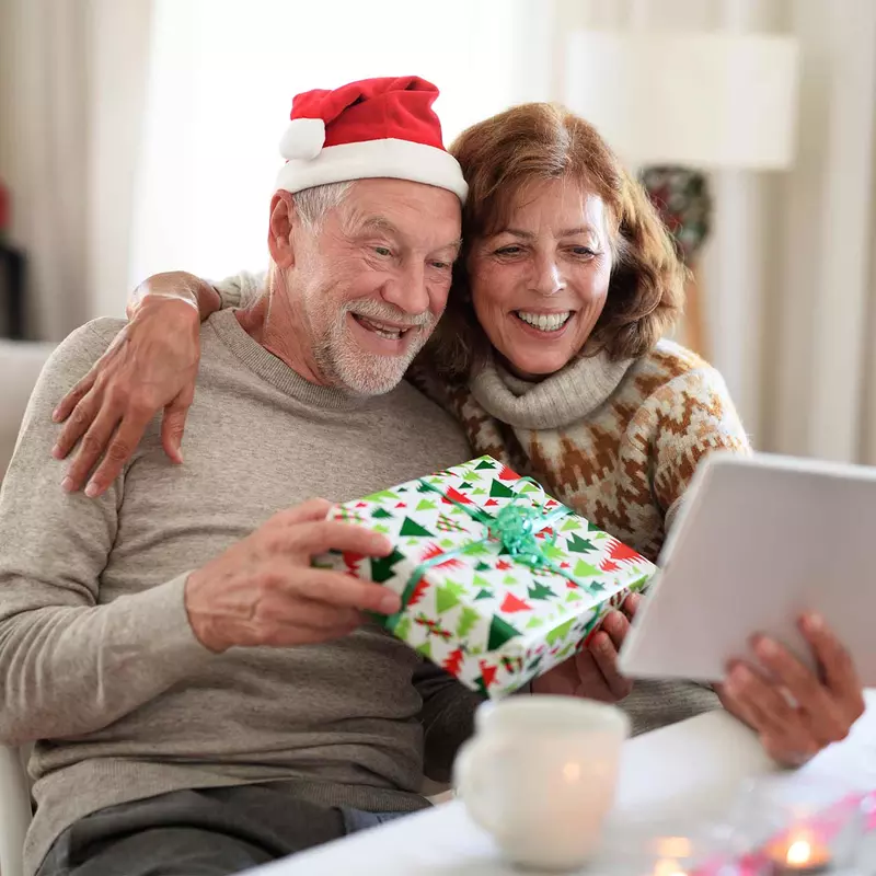 senior couple at home on a Christmas video call with the family