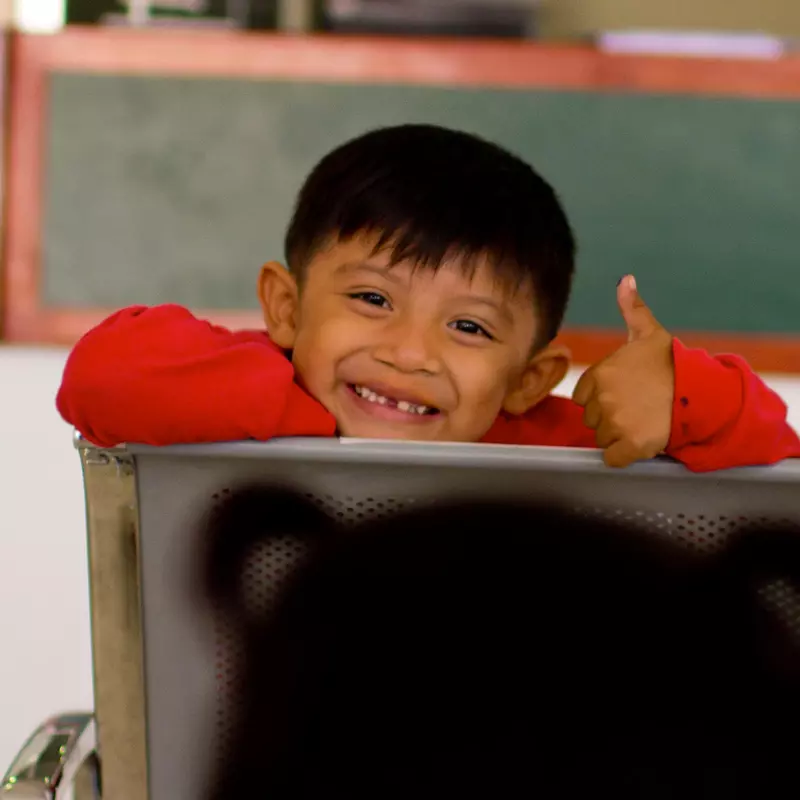 Child smiling in a classroom
