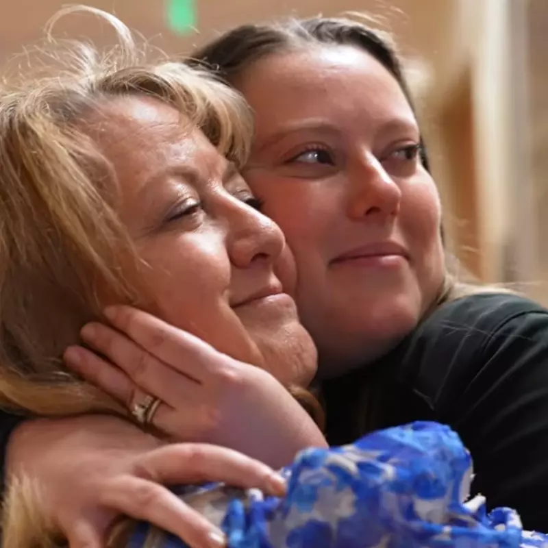 Liver transplant Shelly Kalahar receives a hug.