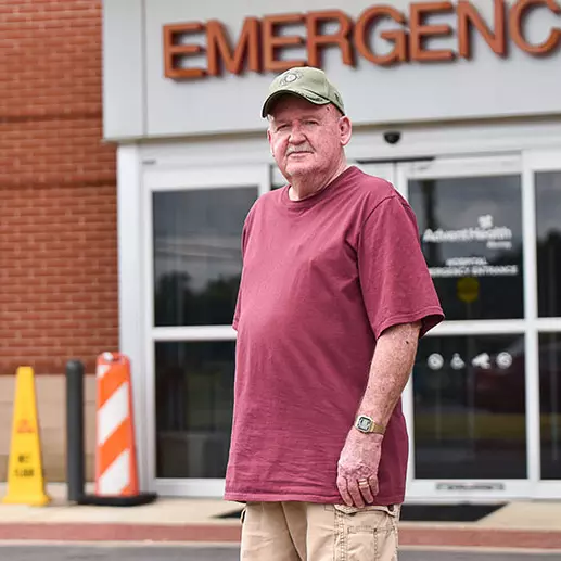 man stands in front of emergency department after suffering a stroke