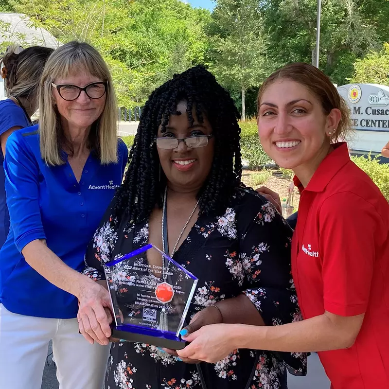 Community Benefit team, Debi McNabb and Ida Babazadeh pose with Shilretha Dixon from the City of DeLand.