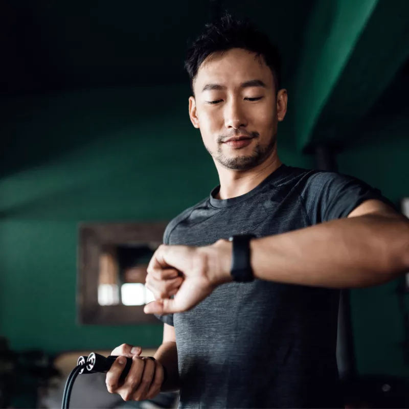 A man checks his heart rate on his smart watch.