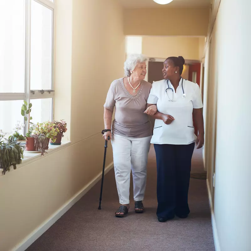 Physician walking with elderly patient