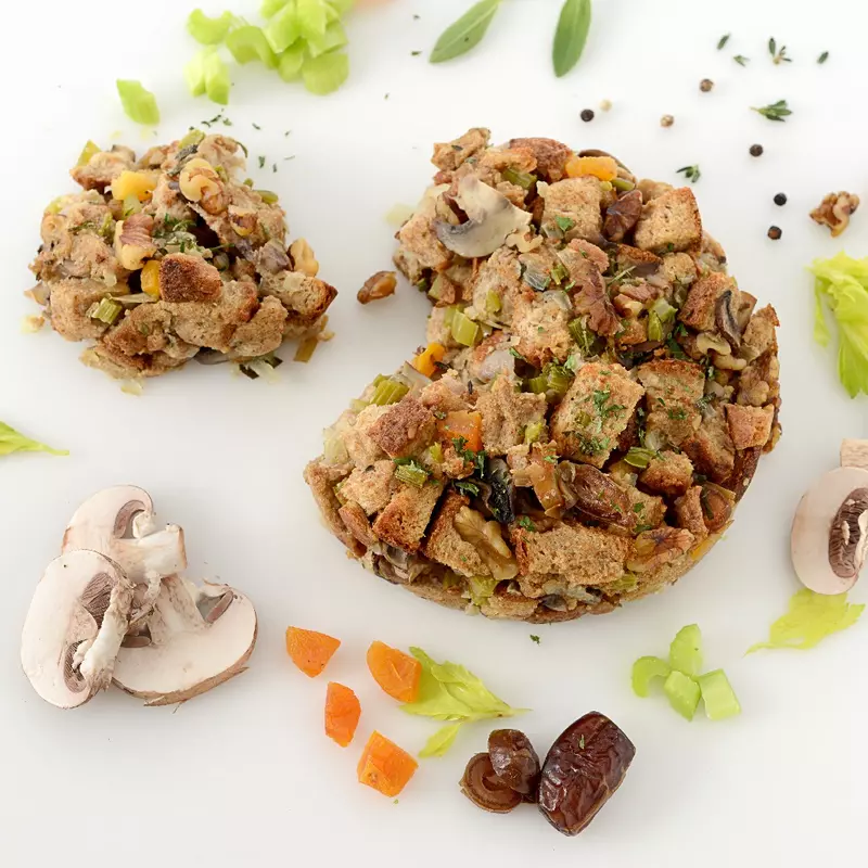 a large pile of stuffing, surrounded by mushrooms and dried fruit