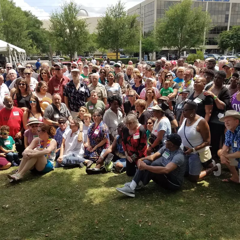 A large group of people gathered for a picnic photo