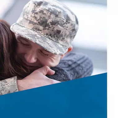 a soldier hugs a family member