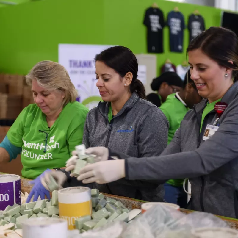 AdventHealth employees and volunteers working with bar soaps and conditioners