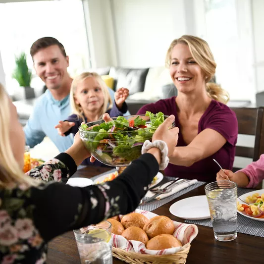 Family enjoys meal together at the dinner table