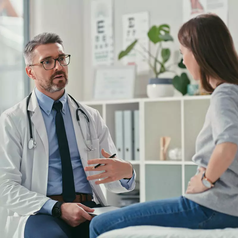 Female patient talking to male doctor