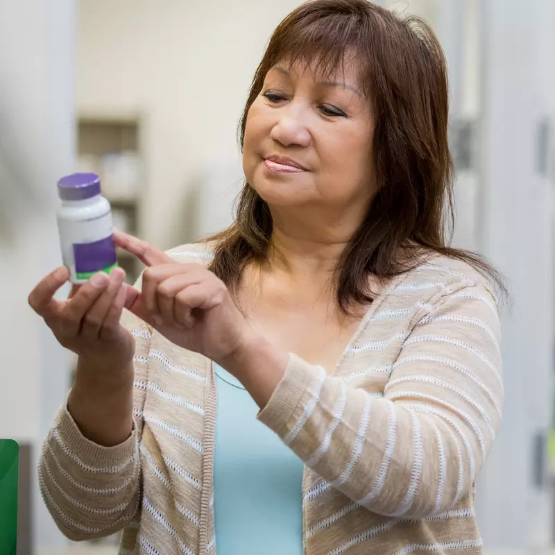 Woman holding medicine bottle