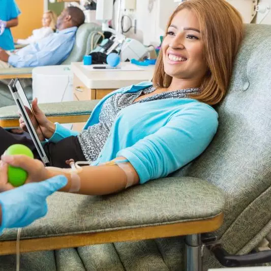 Smiling woman donates blood