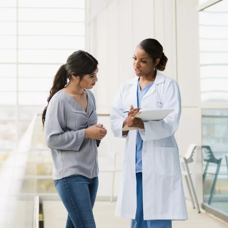 Woman talking with a doctor.