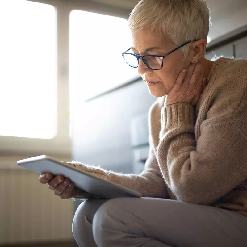 A senior woman on her tablet device