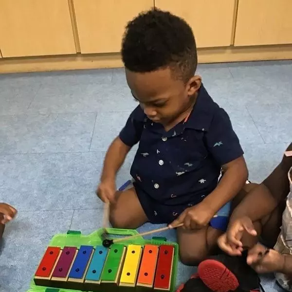 Picture of Xavier playing with a xylaphone at the West Lakes Early Learning Center