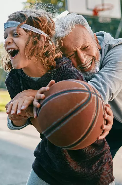 A boy and his grandpa shoot around