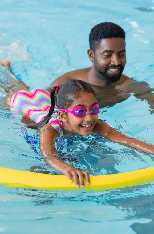 Father and Daughter swimming together at the pool.